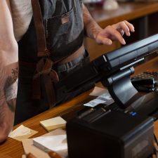 close-up-man-working-cash-register